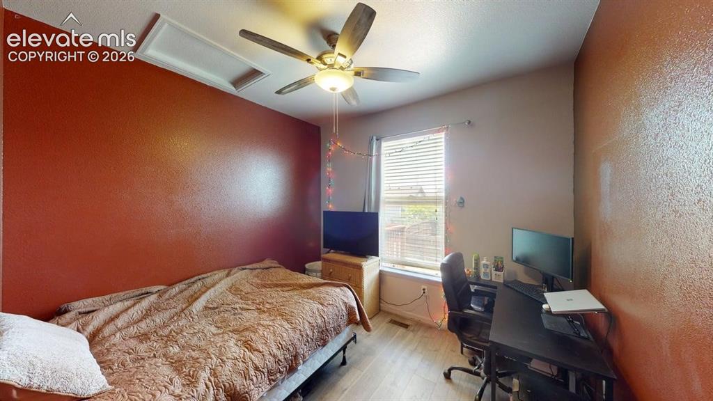 Image 12 of 20: Bedroom featuring wood-finish flooring, a ceiling fan with integrated light