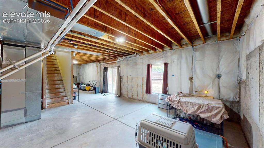 Image 17 of 20: Expansive unfinished basement featuring exposed ceiling joists, concrete fl