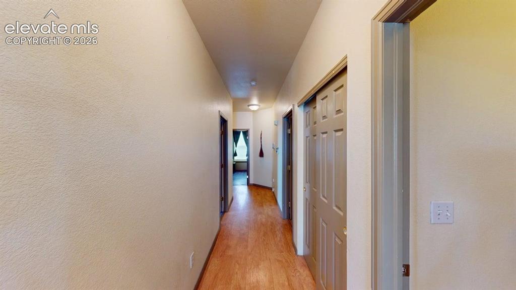 Image 8 of 20: Hallway featuring wood-finish flooring, light-toned walls, and recessed lig