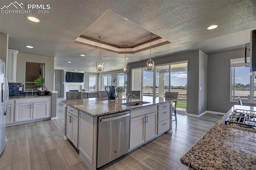 Image 18 of 50: Gourmet kitchen featuring a large island with granite countertops, stainles