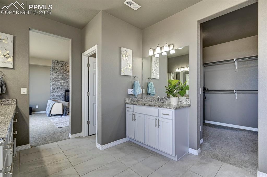 Image 35 of 50: Bathroom vanity area featuring tile flooring and a double sink vanity with 