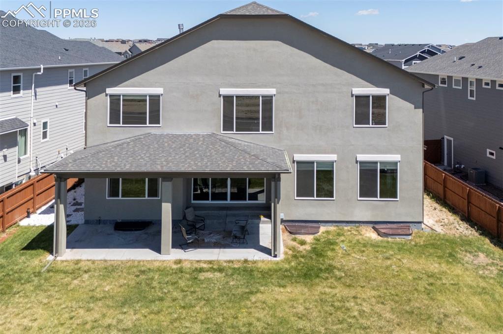 Image 48 of 50: Rear exterior featuring stucco finish, a covered patio with a concrete slab