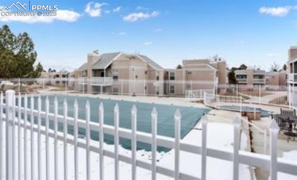 Image 15 of 16: Community pool featuring a residential view