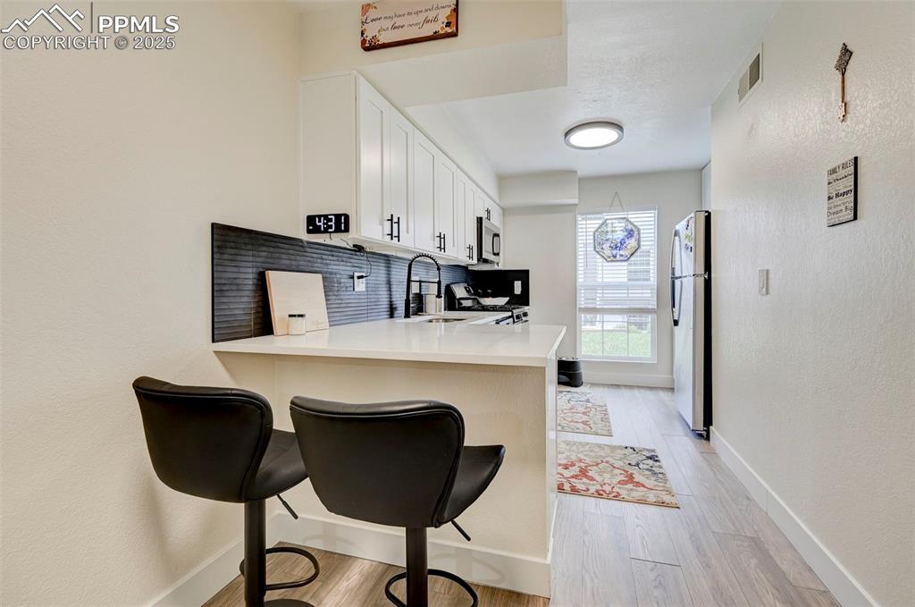 Image 4 of 16: Kitchen featuring appliances with stainless steel finishes, a kitchen break