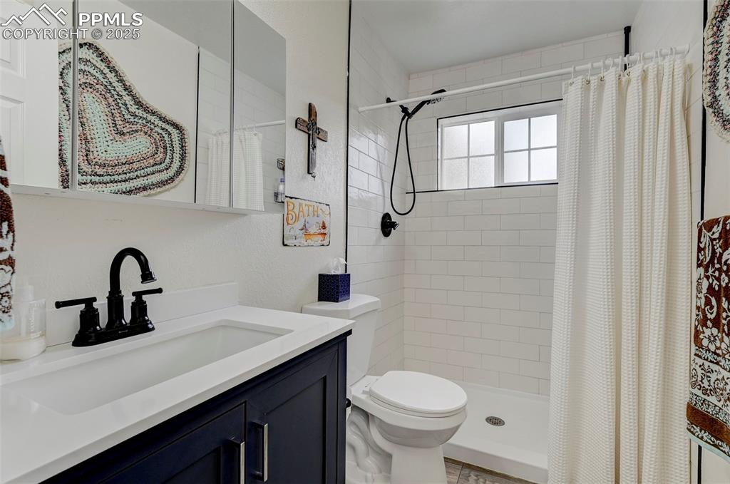 Image 7 of 16: Bathroom featuring vanity and tiled shower