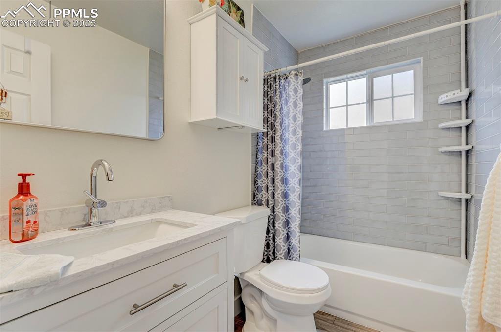 Image 9 of 16: Bathroom with vanity and shower / bath combo with shower curtain