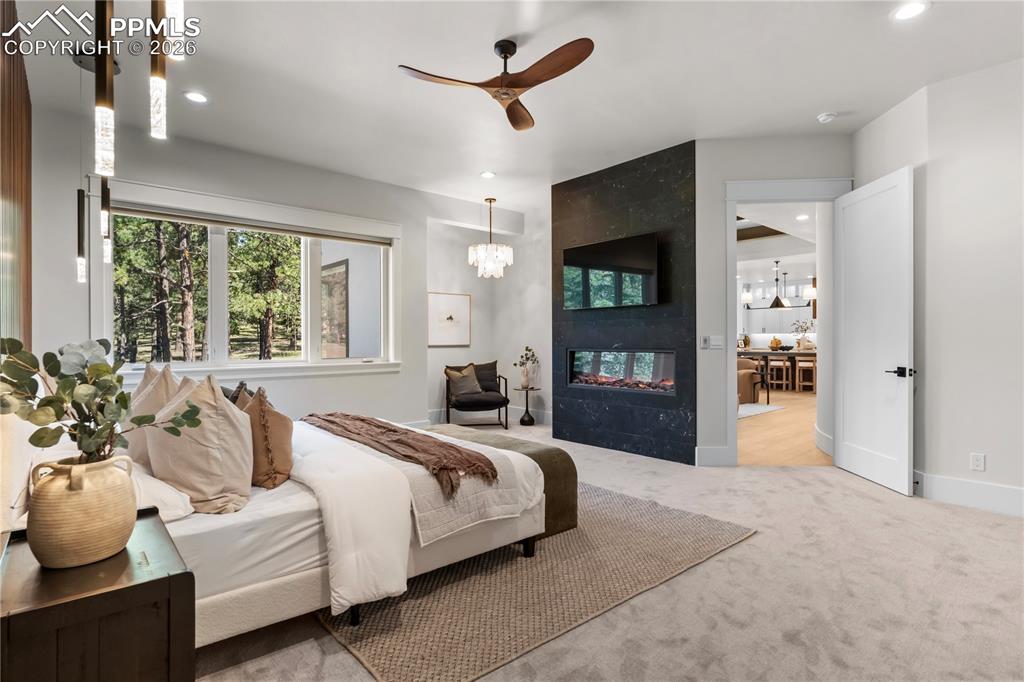 Image 23 of 48: Primary Bedroom with electric fireplace and reading nook