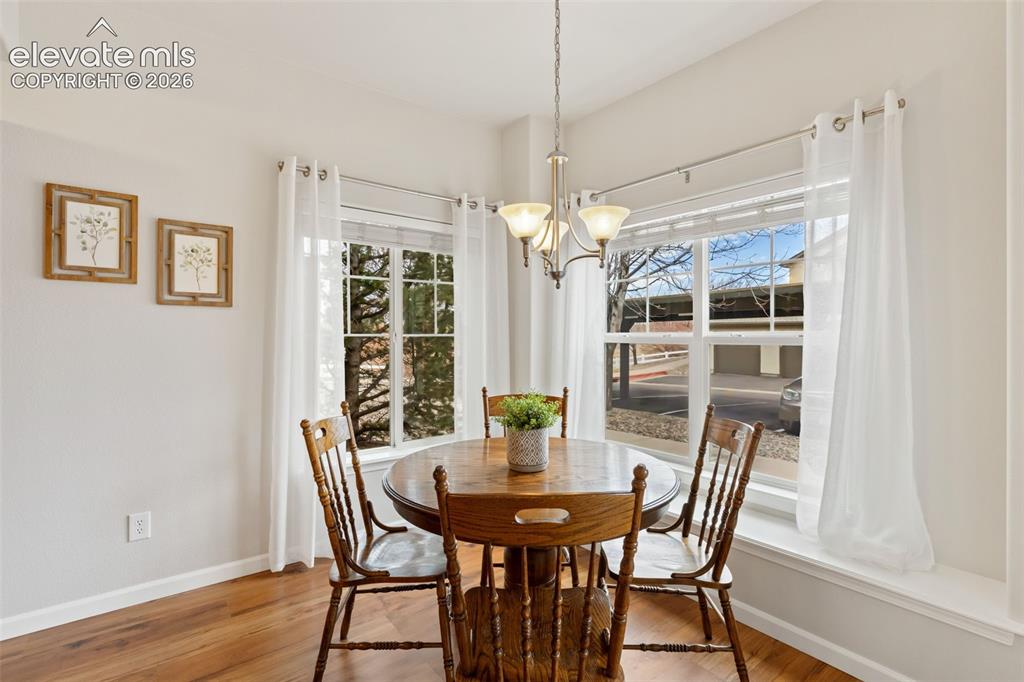 Image 10 of 31: Recessed ceiling with an attached chandelier, multiple windows with white t