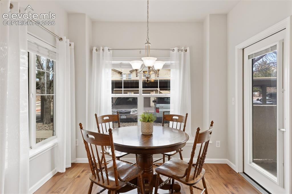 Image 11 of 31: Wood-finish flooring with white trim