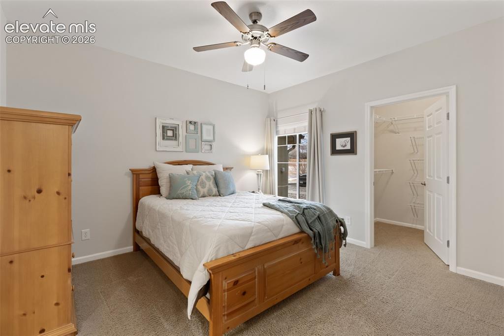 Image 13 of 31: Vaulted ceiling, ceiling fan with light fixture, window with curtains, carp