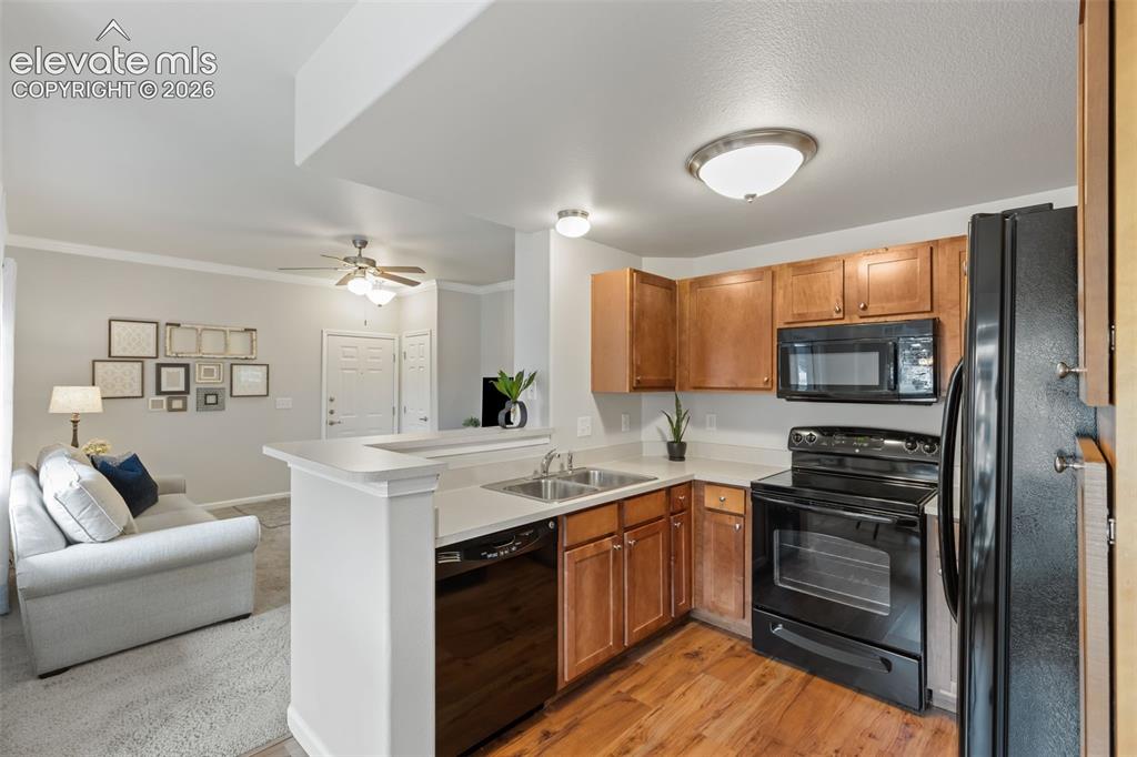 Image 5 of 31: Open-concept kitchen featuring wood-finish flooring, light wood cabinetry, 