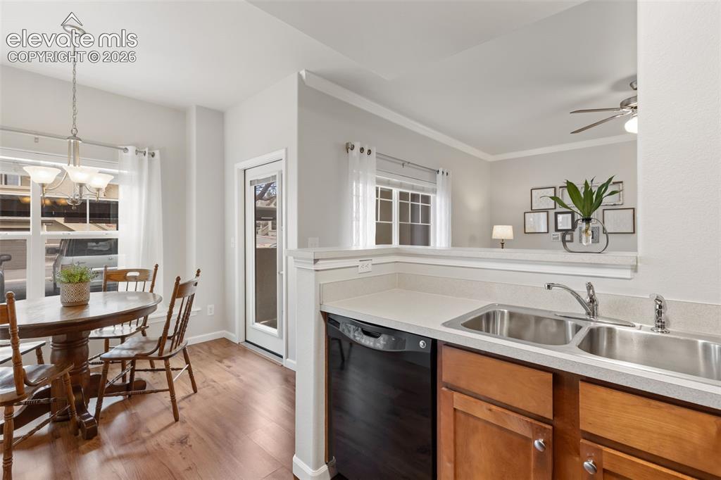 Image 8 of 31: Wood-finish flooring, white trim, a double-basin stainless steel sink, a bl