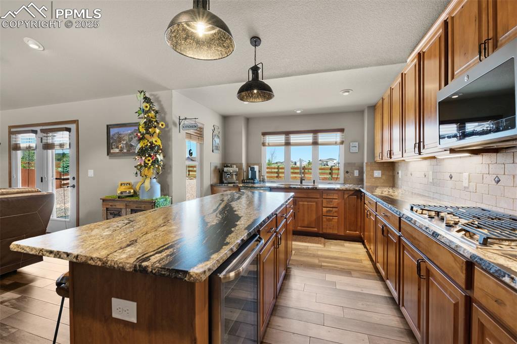 Image 14 of 48: Kitchen featuring wine cooler, appliances with stainless steel finishes, a 