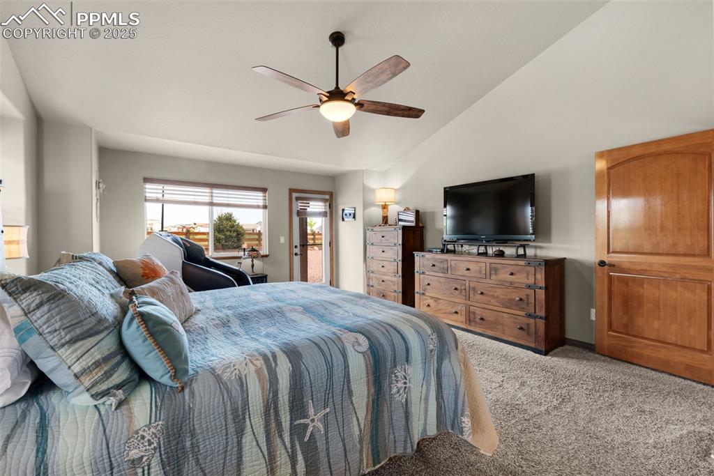 Image 17 of 48: Bedroom featuring carpet, lofted ceiling, and ceiling fan