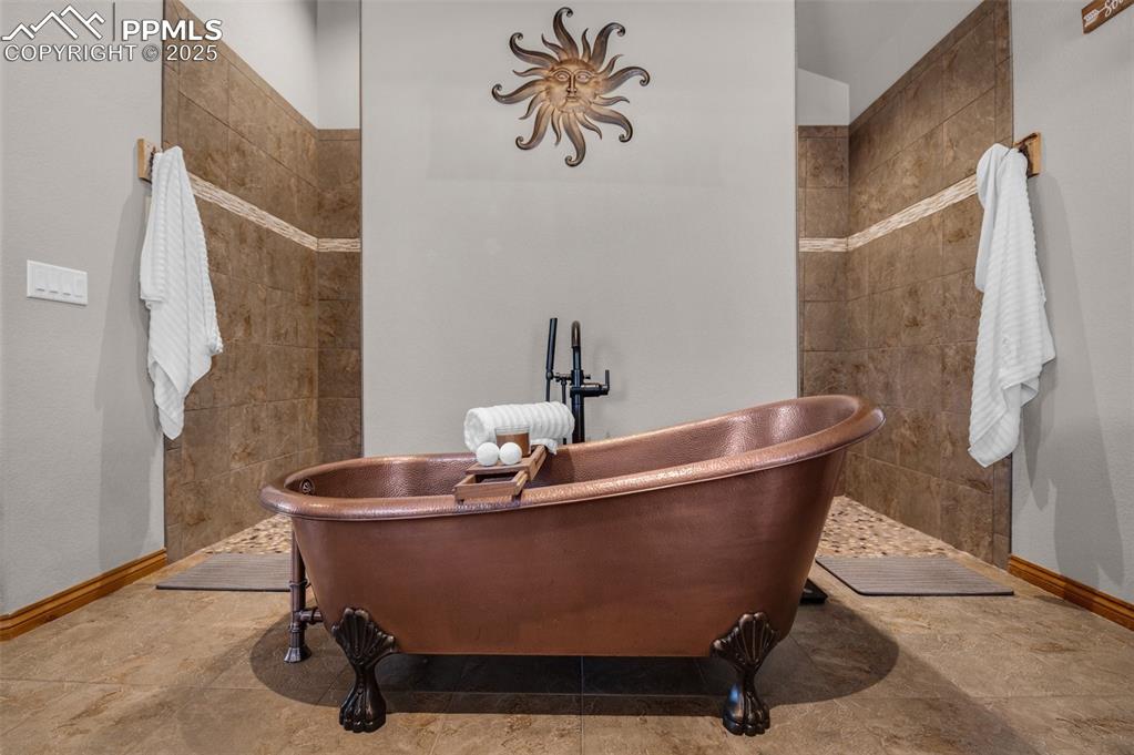 Image 19 of 48: Bathroom with a freestanding bath and walk in shower