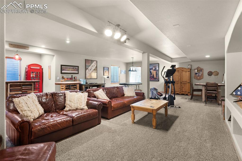 Image 30 of 48: Carpeted living area featuring recessed lighting