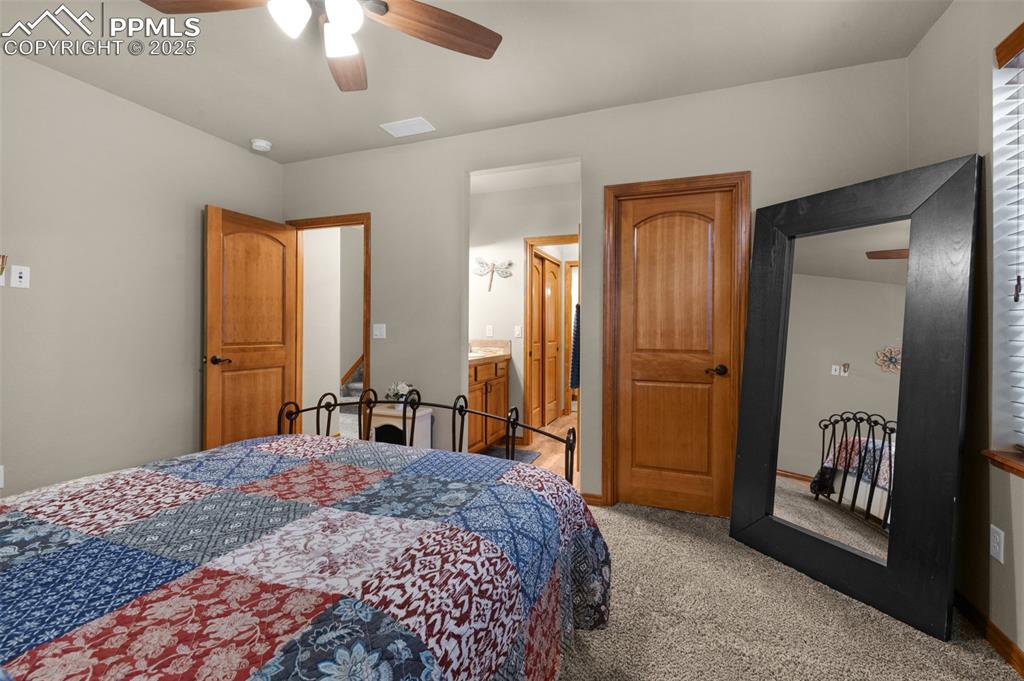 Image 35 of 48: Bedroom featuring light colored carpet and ceiling fan