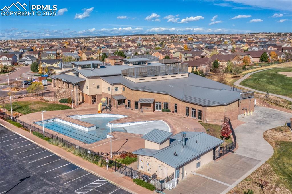 Image 46 of 48: Aerial perspective of suburban area with a pool