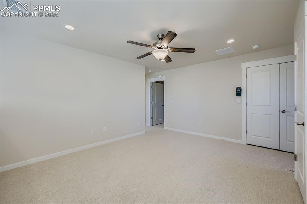 Image 24 of 27: Unfurnished bedroom featuring recessed lighting, light carpet, and a ceilin