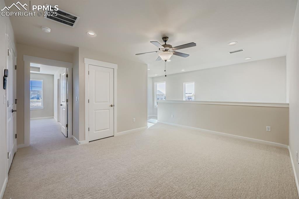 Image 25 of 27: Spare room with light carpet, plenty of natural light, recessed lighting, a