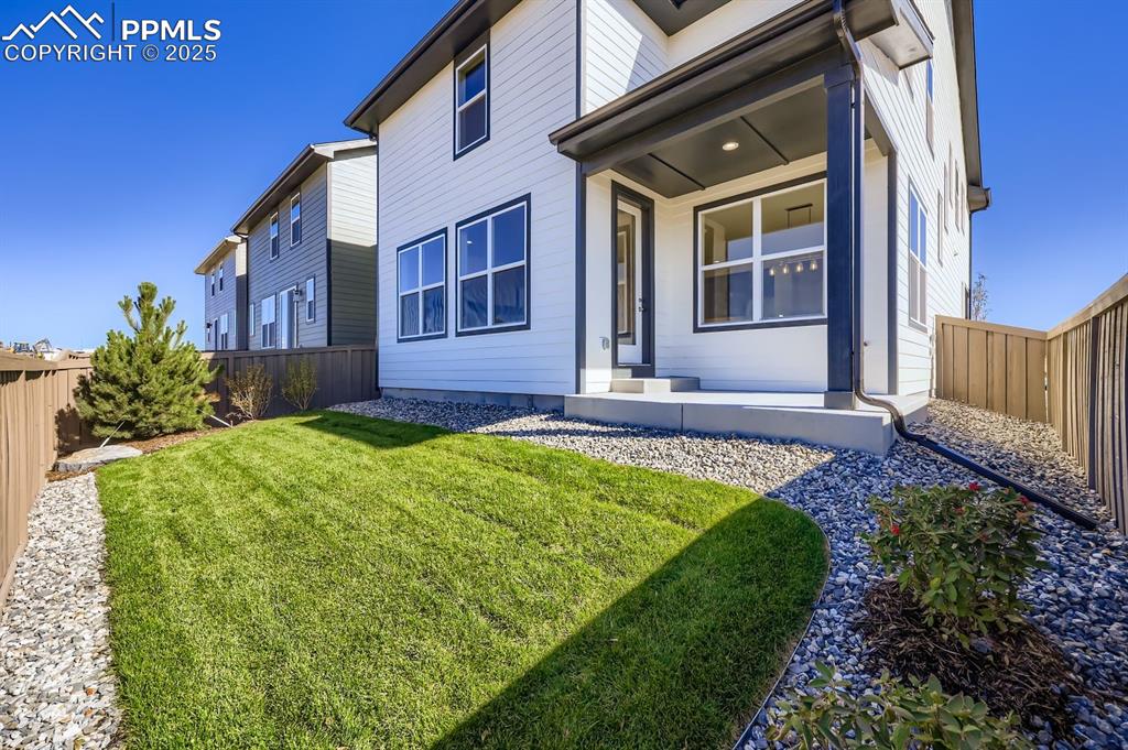 Image 27 of 27: Back of house featuring a fenced backyard