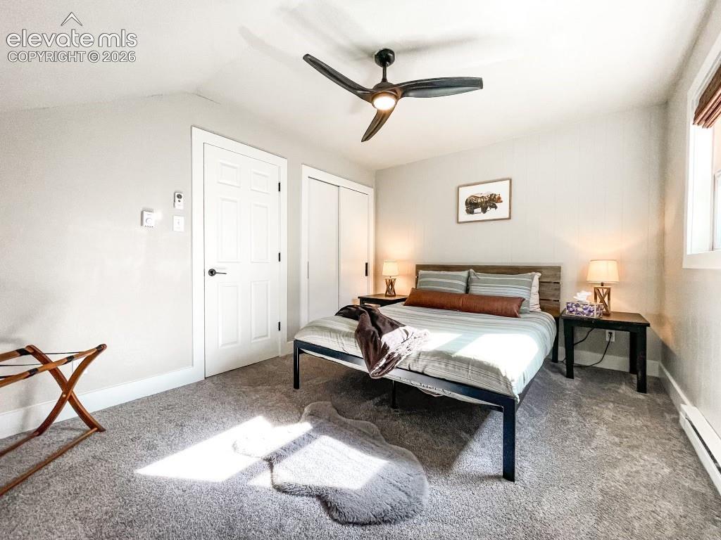 Image 14 of 29: Carpeted room featuring a ceiling fan with integrated lighting, a paneled d