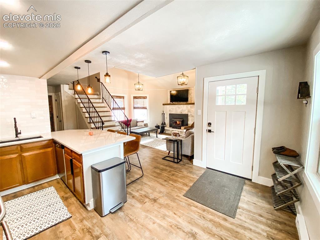 Image 21 of 29: Open-concept living space featuring wood-finish flooring, a kitchen island 