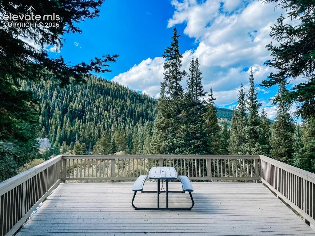 Image 28 of 29: Expansive outdoor deck featuring wood-finish decking and perimeter railing