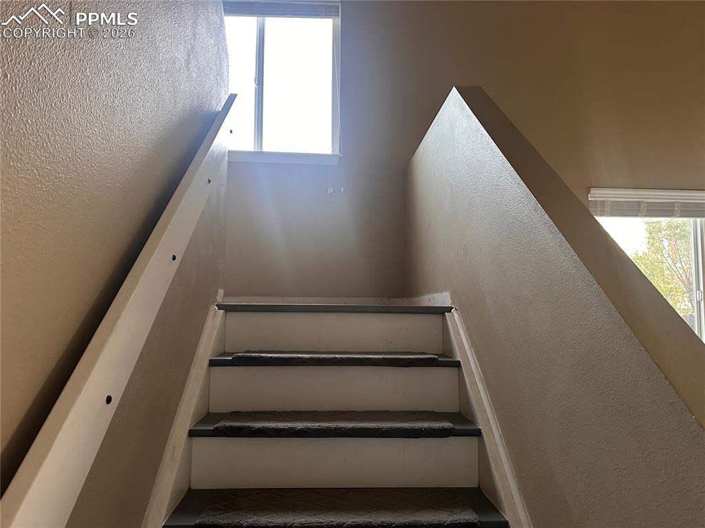 Image 17 of 33: Stairs going up to 2nd level