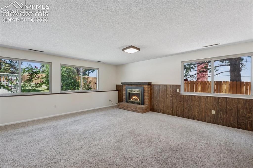 Image 12 of 42: Flexible Living and Dining Space (with furniture) Lower Level