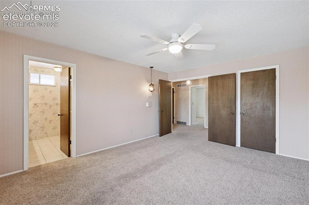 Image 14 of 42: Spacious room featuring neutral carpet, a ceiling fan with integrated light