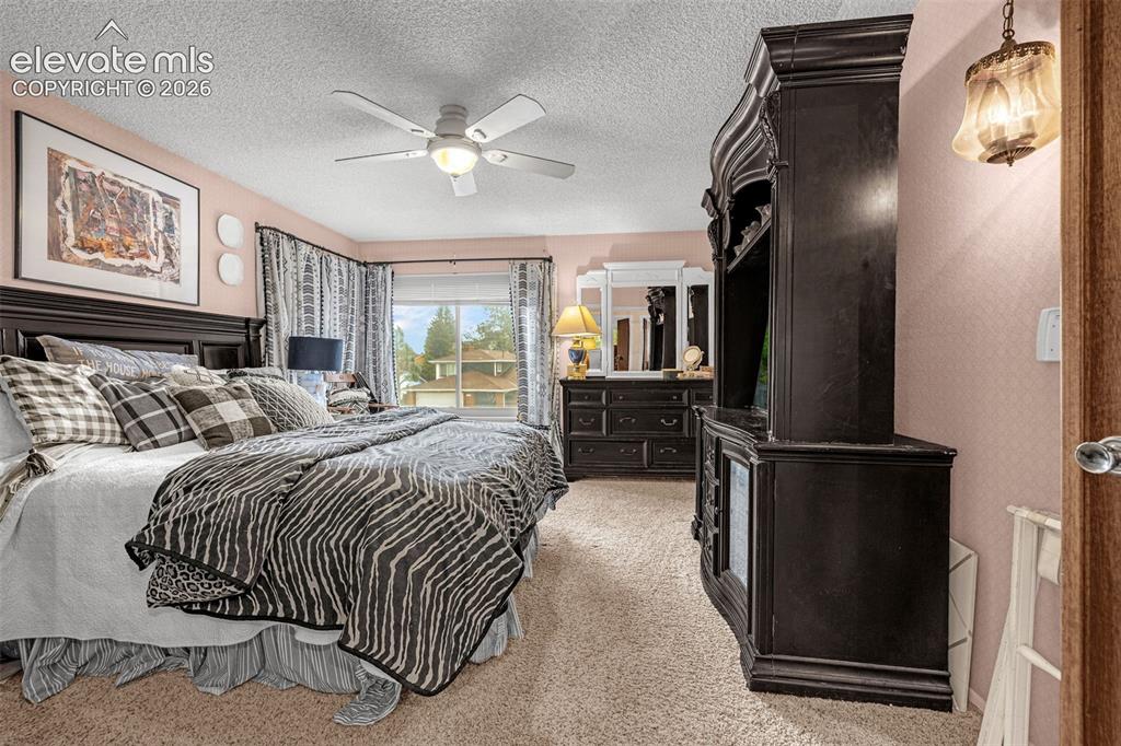Image 15 of 45: Carpeted flooring, ceiling fan with integrated lighting, and multiple windo