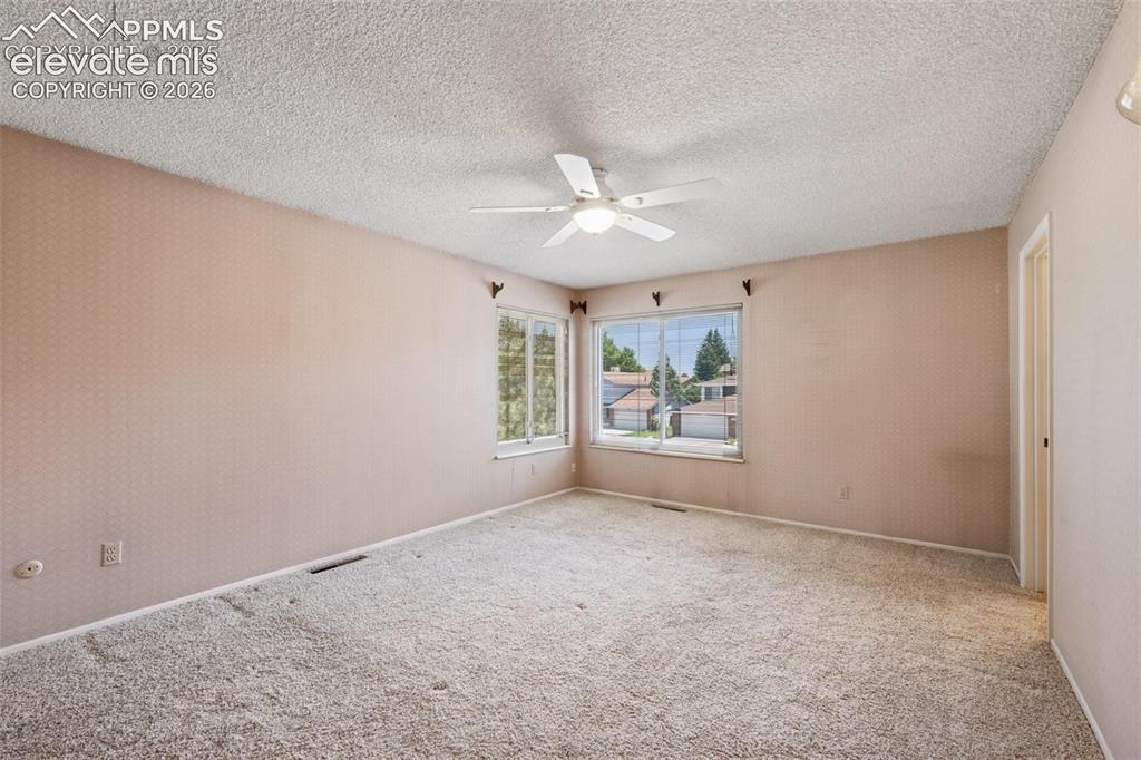 Image 15 of 42: Wall-to-wall carpeting and a ceiling fan with integrated lighting