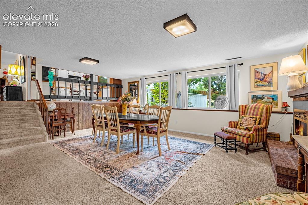 Image 25 of 45: Carpeted flooring throughout, recessed windows, built-in fireplace with bri