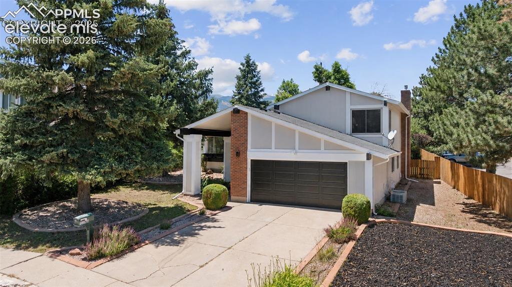 Image 3 of 42: Contemporary exterior with an attached two-car garage