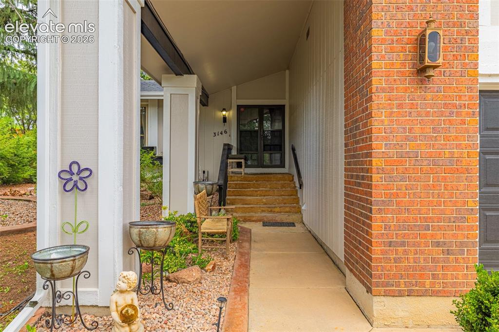 Image 4 of 45: Brick exterior with an inviting covered entry