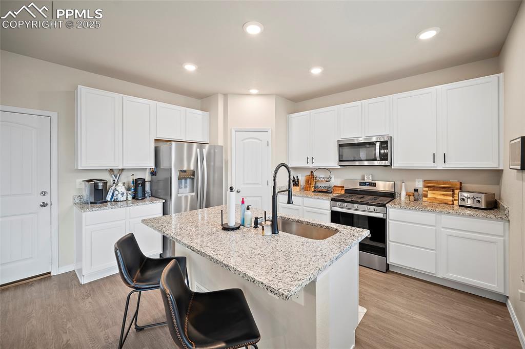 Image 11 of 40: Kitchen featuring appliances with stainless steel finishes, gas stove, a ki