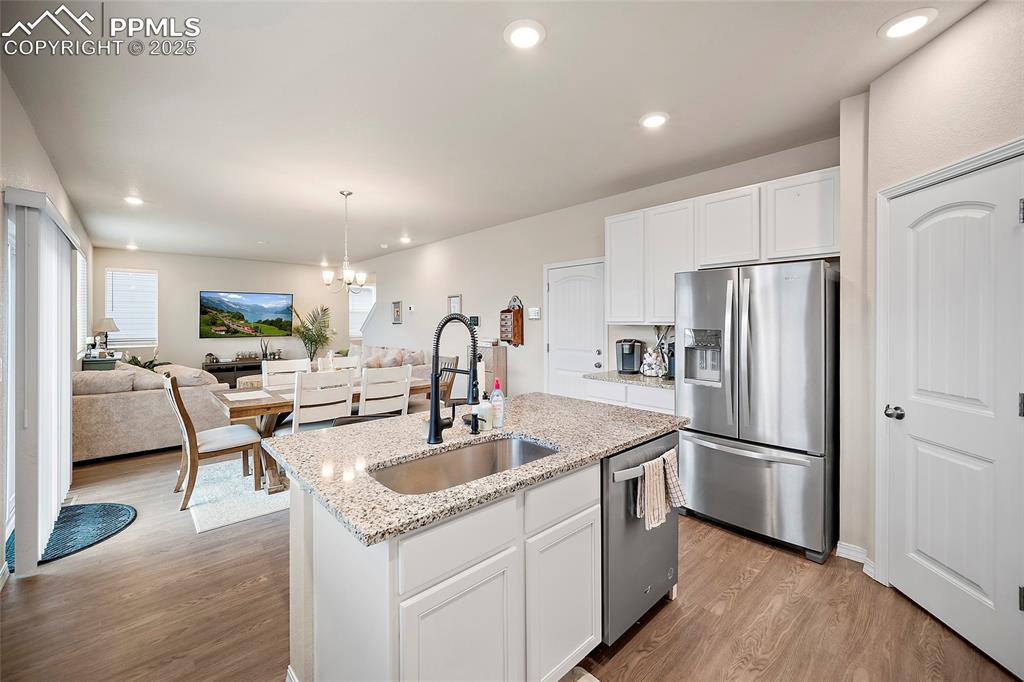 Image 12 of 40: Kitchen view to dining room and living room.