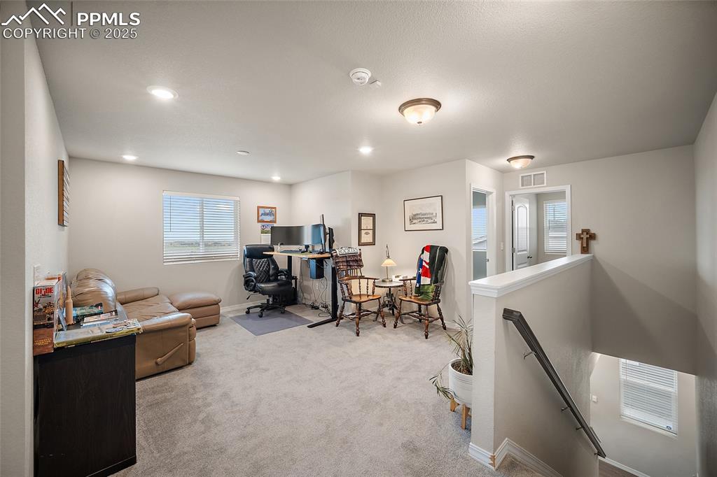 Image 13 of 40: Loft area with access to laundry room and bedroom 1.
