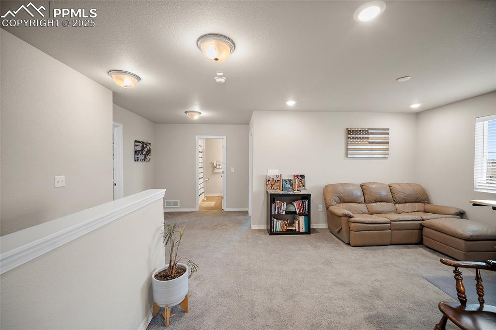 Image 14 of 40: upstairs loft with access to a full bathroom, laundry room and all three be