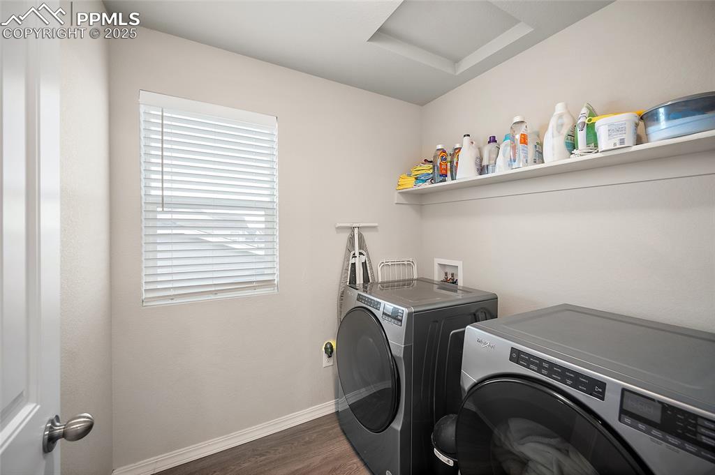 Image 15 of 40: Laundry room with separate washer and dryer and lvp floors.