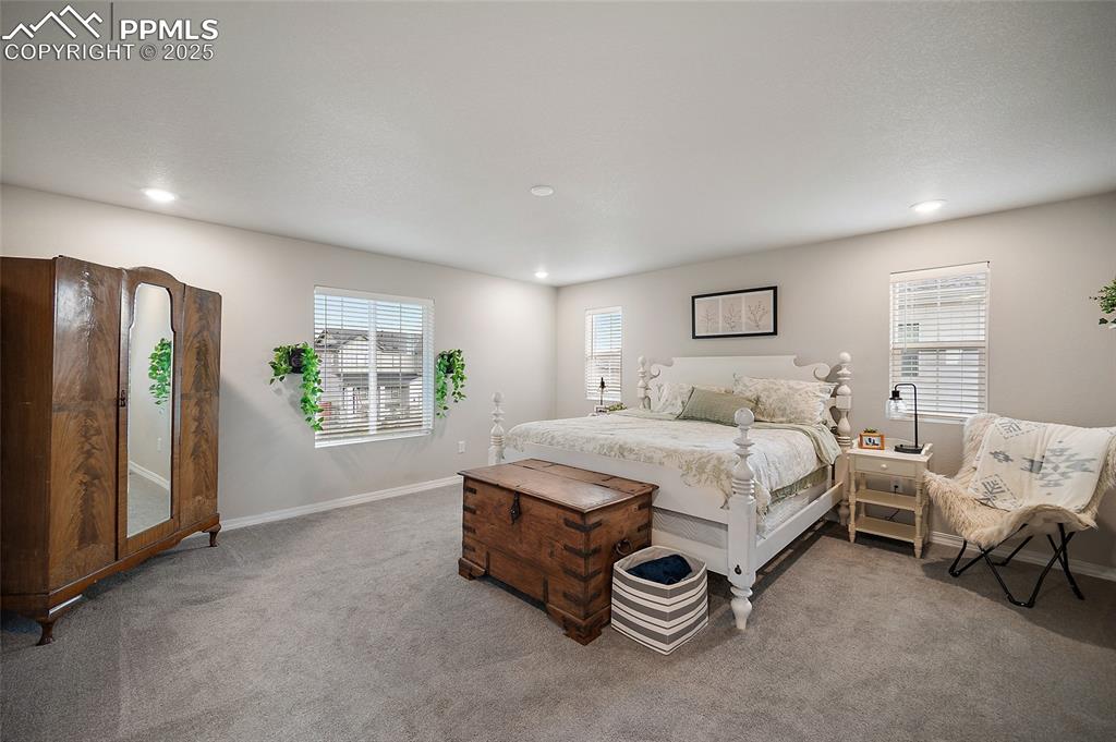 Image 21 of 40: Primary Bedroom located above the garage. Large window faces west.