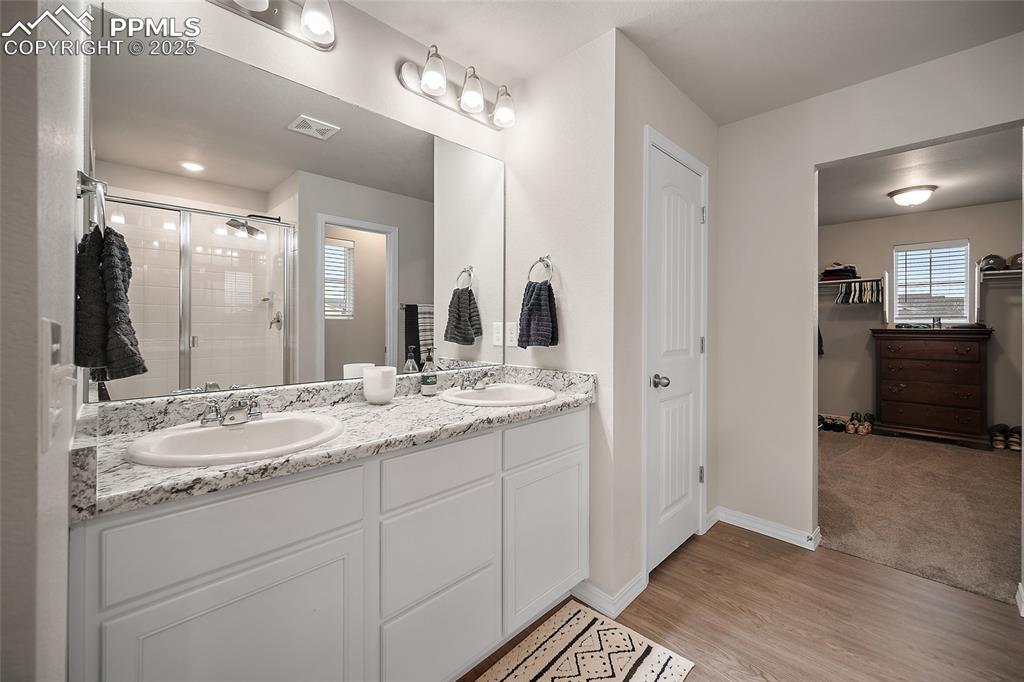 Image 24 of 40: Primary bathroom featuring a double vanity, linen closet, primary closet ac