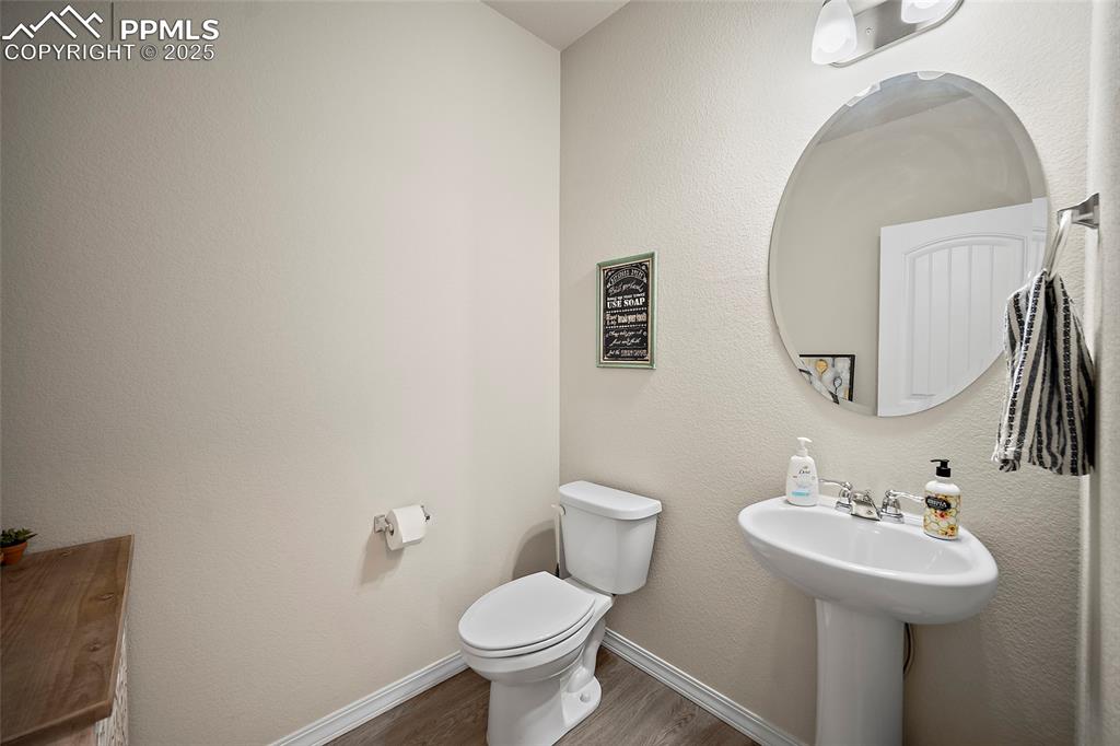 Image 7 of 40: Half Bathroom located off the front entrance.