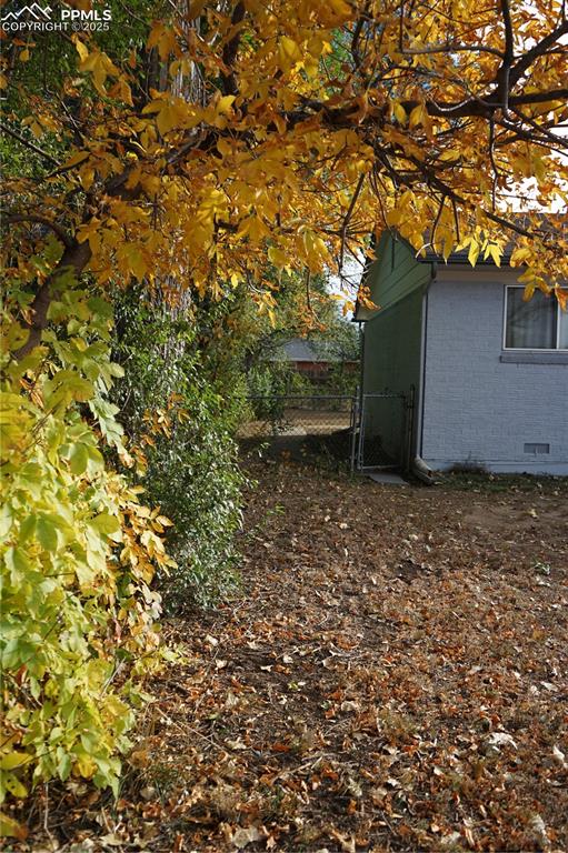 Image 19 of 22: View of yard featuring a gate