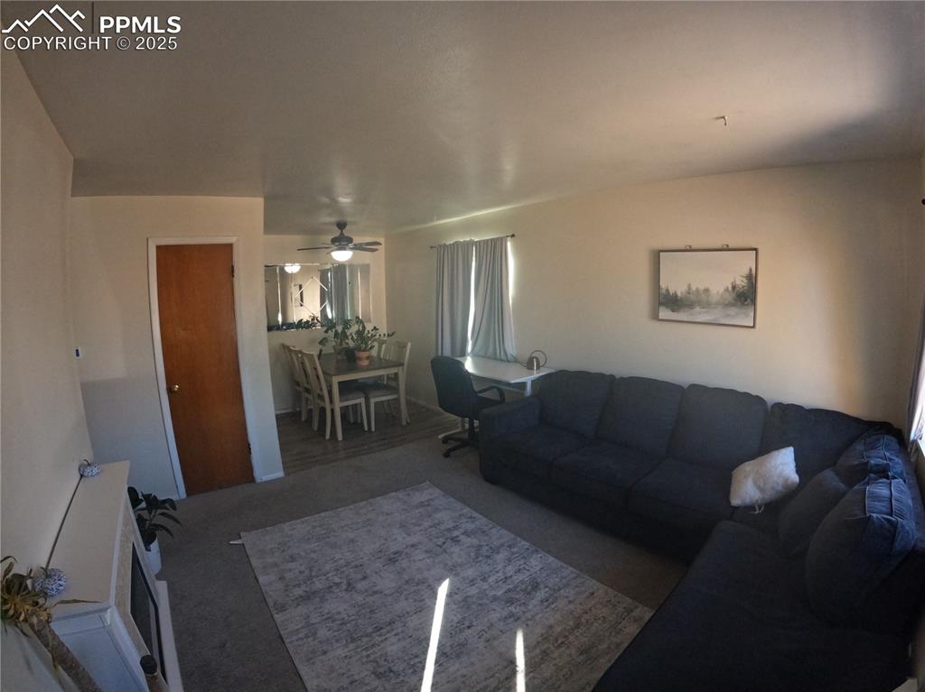 Image 3 of 22: Carpeted living area featuring a ceiling fan