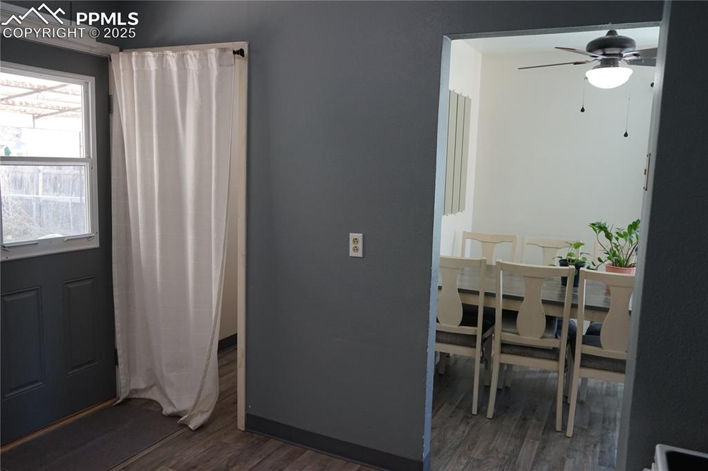 Image 7 of 22: View from the kitchen to dining area and laundry room/back door