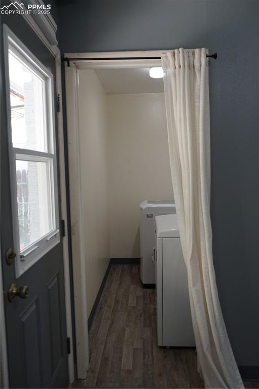 Image 8 of 22: Washroom with dark wood-style flooring and separate washer and dryer