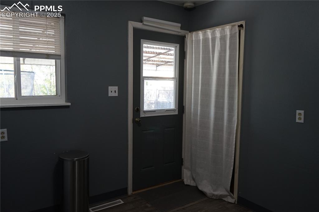 Image 9 of 22: Doorway featuring wood finished floors
