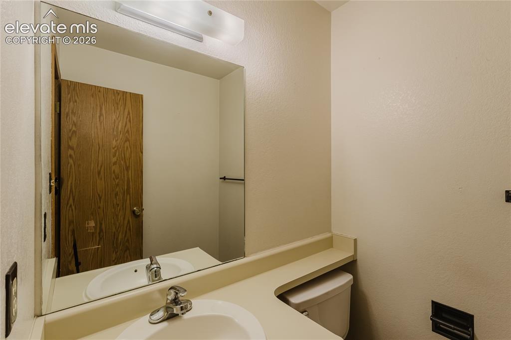 Image 10 of 32: Main level half bath